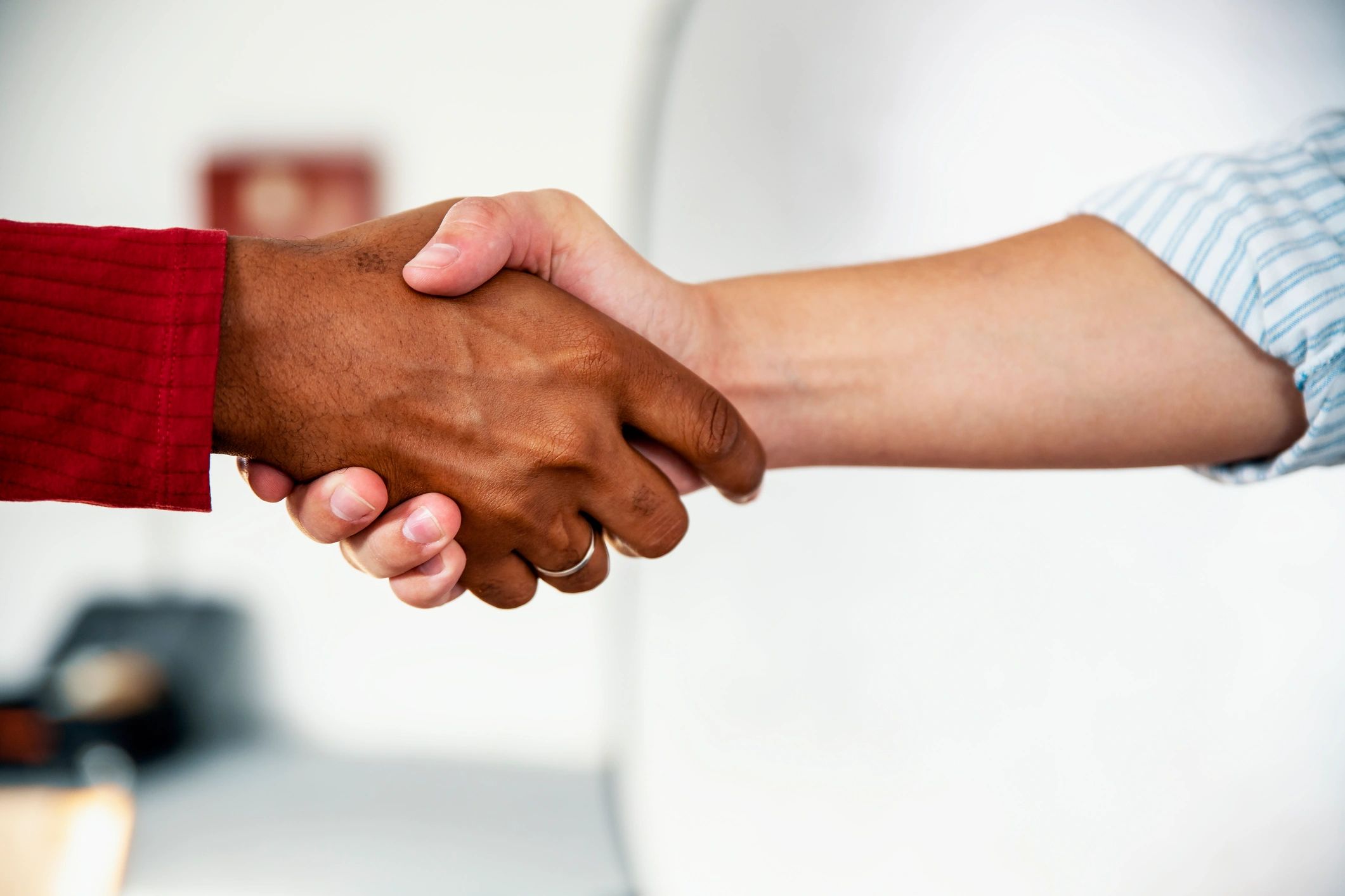 Partners shaking hands to confirm responsible cooperation