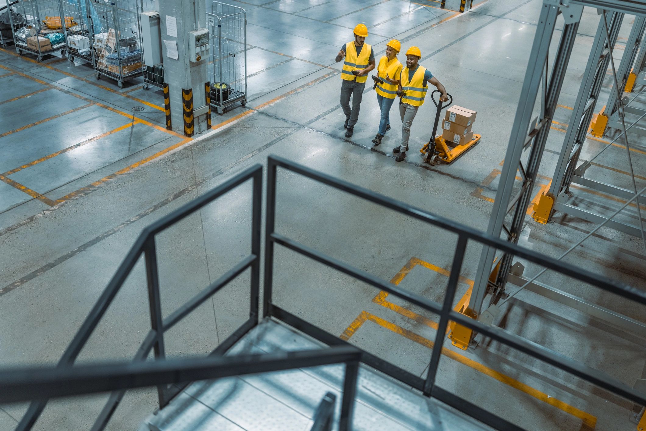 Warehouse workers coordinating an inventory shift